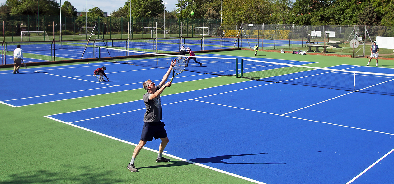 Tennis players on hard courts, after coronavirus restrictions are eased